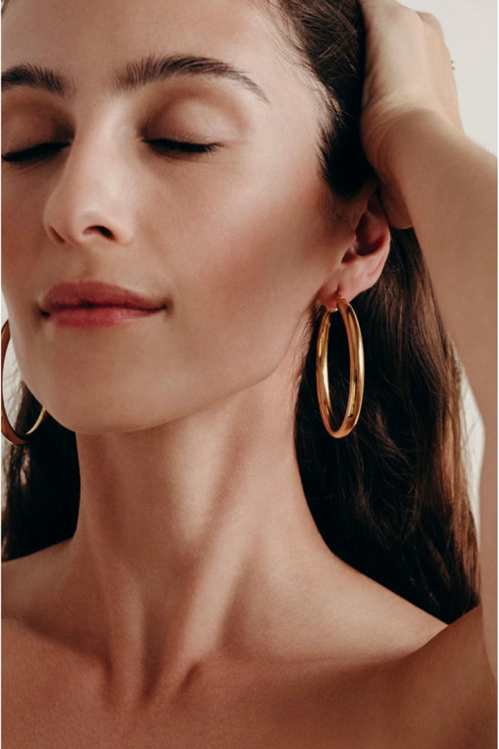woman wearing gold hoop earrings