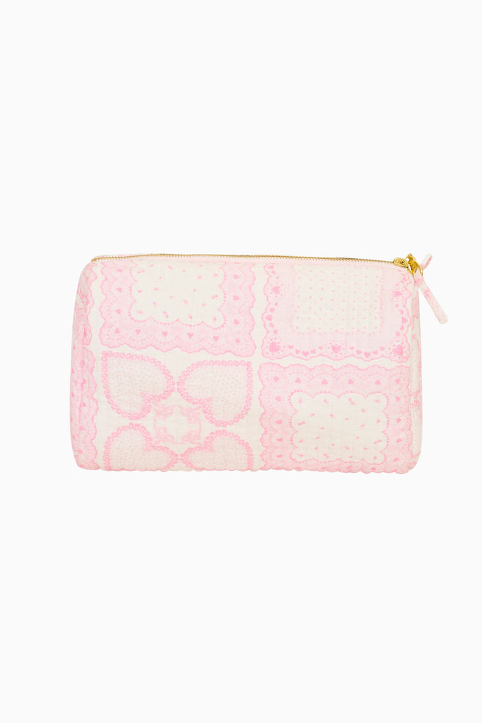 Pink quilted pouch with heart pattern on a white background
