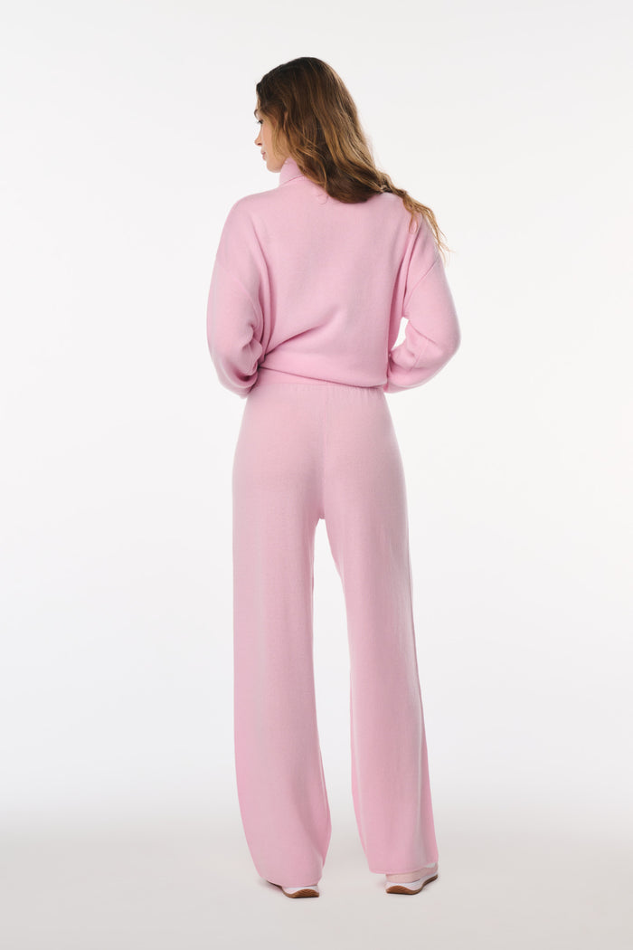 Woman wearing a pink outfit on a white background