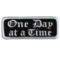 One Day At a Time Patch 4 Inch: Description
"One Day at a Time" embroidered in fancy white lettering on a black background wi