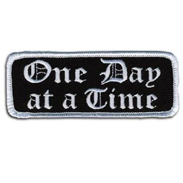 One Day At a Time Patch 4 Inch: Description
"One Day at a Time" embroidered in fancy white lettering on a black background wi